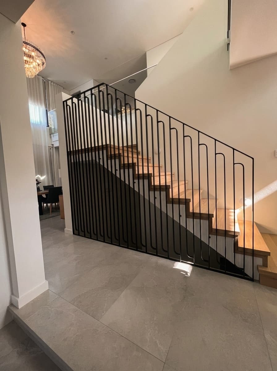 Black metal staircase balustrade by Fabcon Fabrications